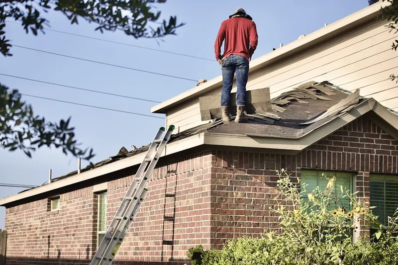 Professional roofer working on a residential roof in Hubbard Heights
